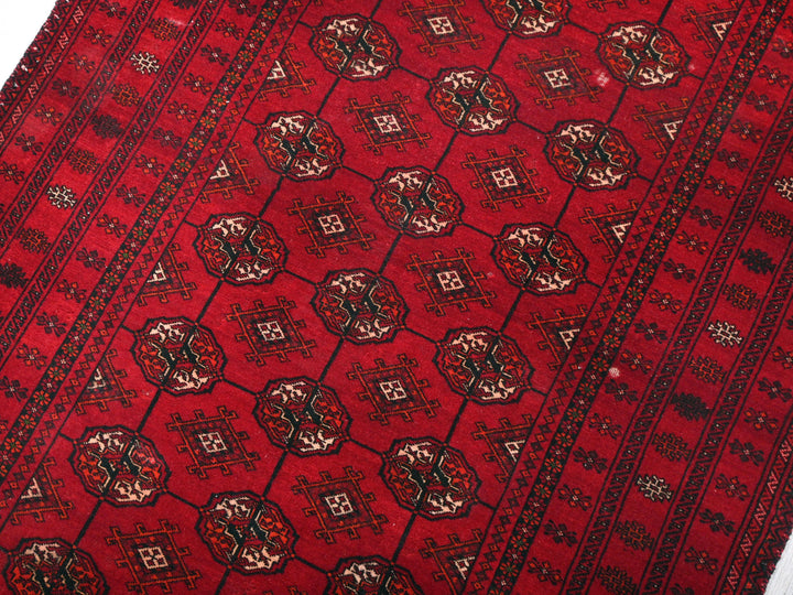 a red rug with a design on it
