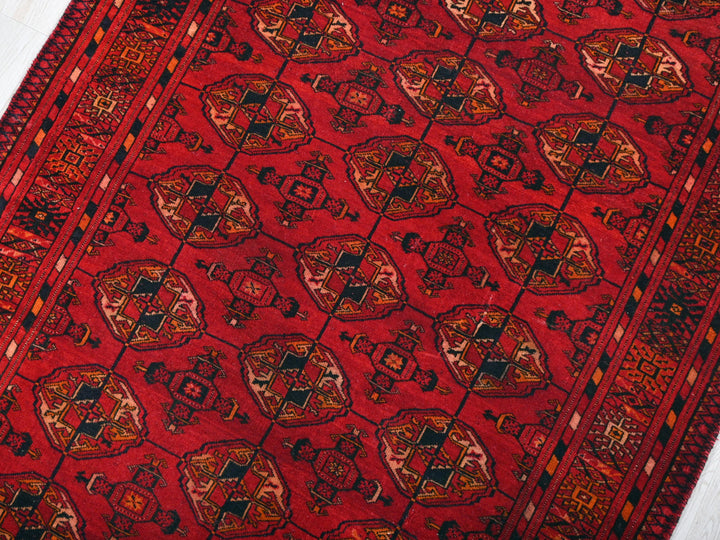 a red rug with a design on it