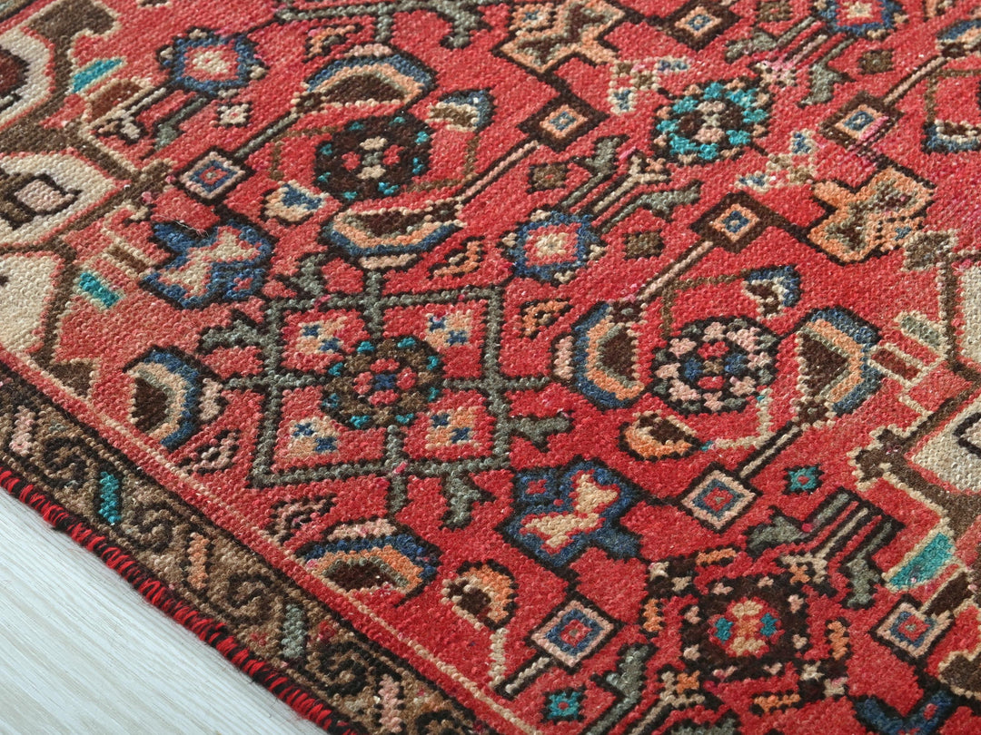 a close up of a red oriental rug