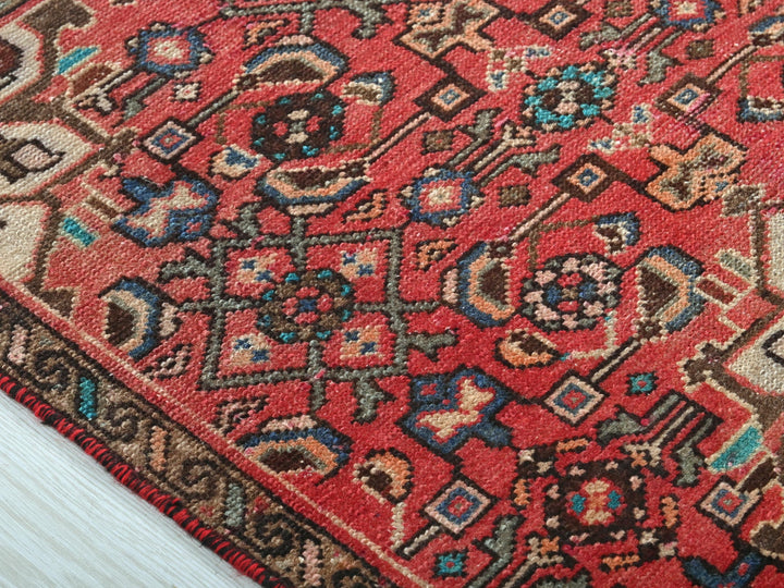 a close up of a red oriental rug