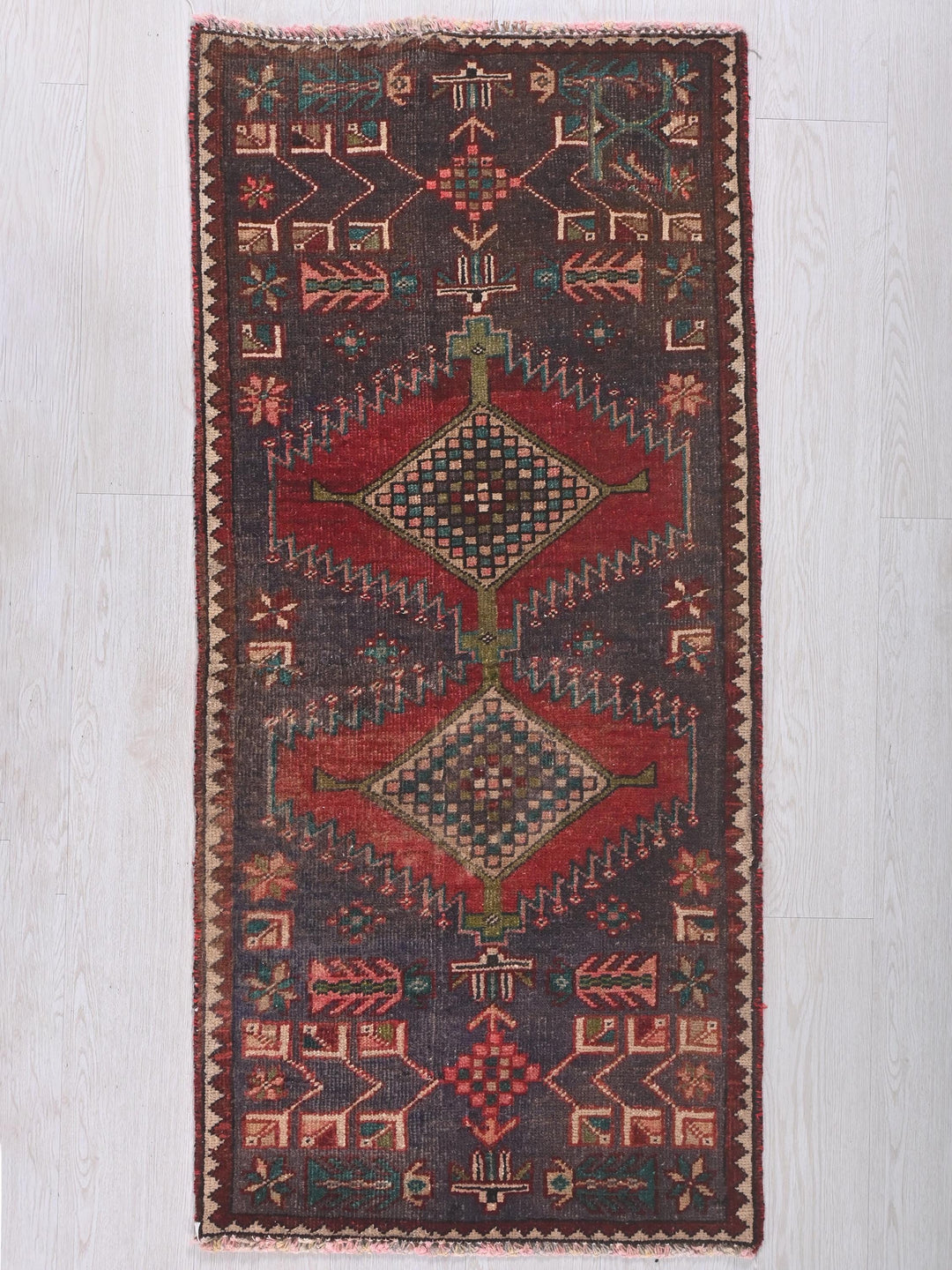 a multicolored rug on a white wooden floor