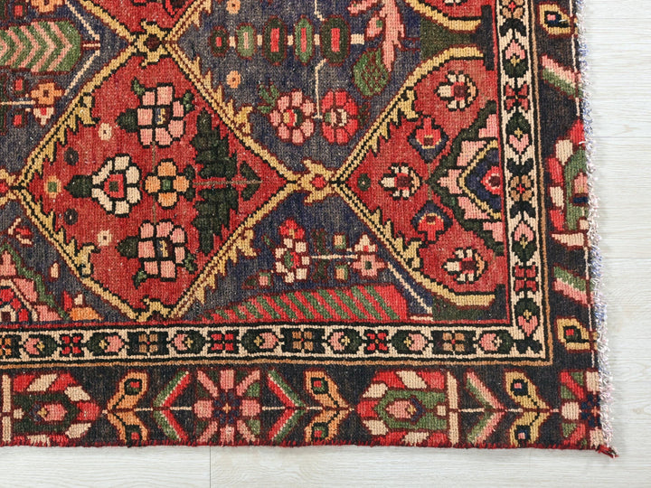 a red rug with a floral design on it