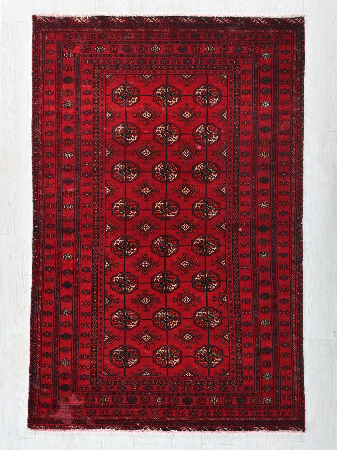 a red rug with a design on it