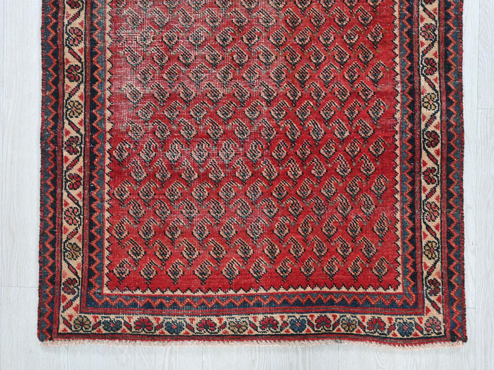 a red rug with a diamond pattern on it