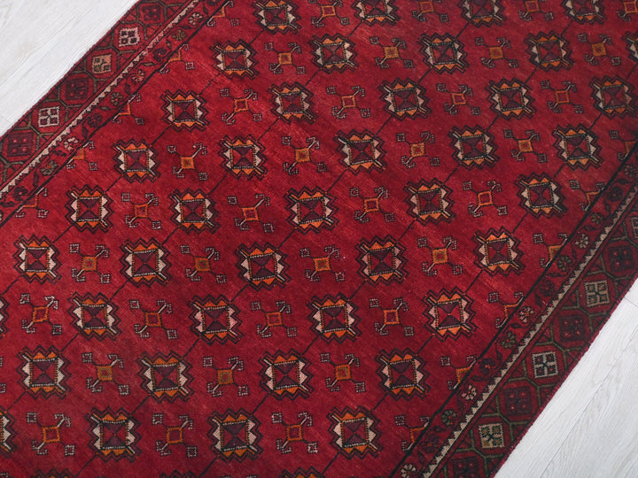 a red rug with a design on it