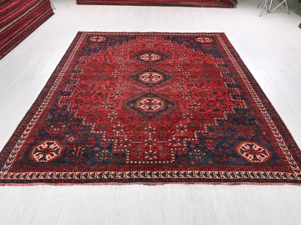 a large red rug on a white floor