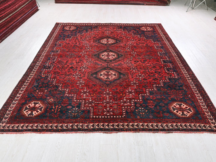 a large red rug on a white floor