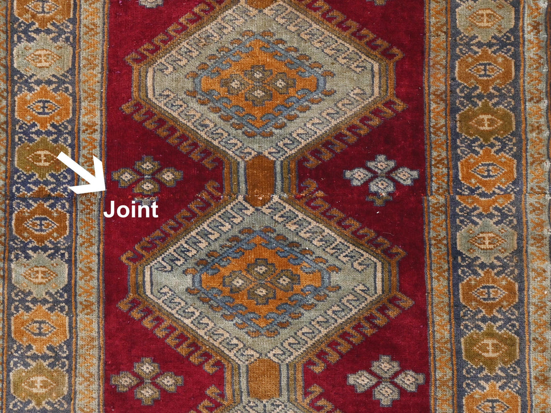 a close up of a rug with a red background