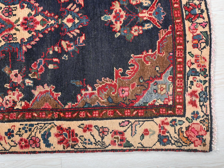 a blue rug with red and blue flowers on it