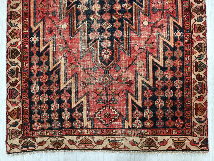 a red and black oriental rug on a white background