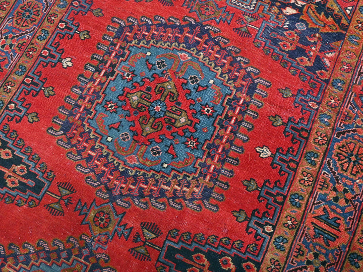 a red rug with a blue and red design on it