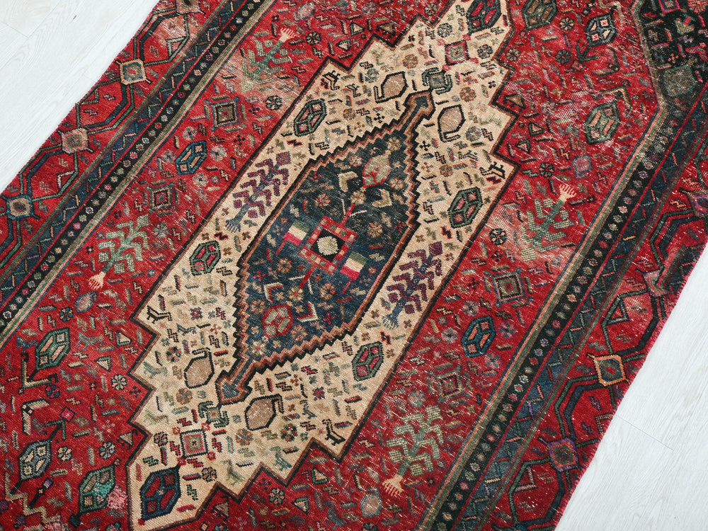 a red rug with an intricate design on it