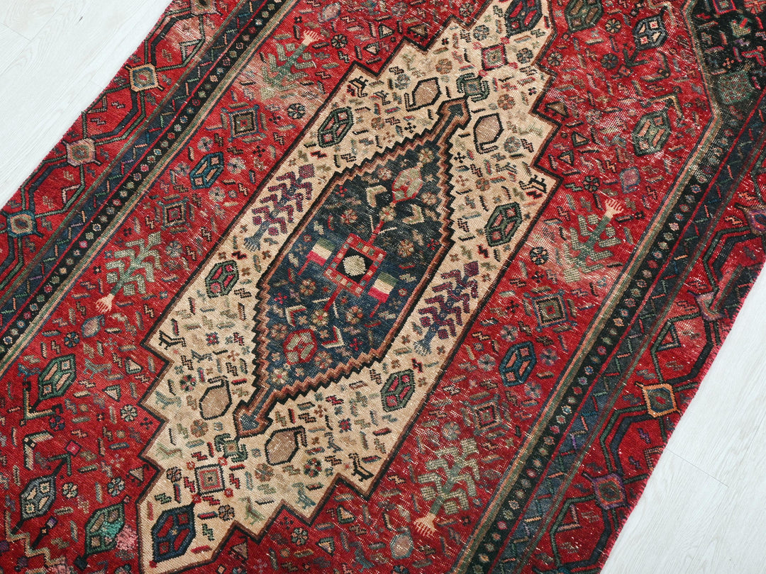 a red rug with an intricate design on it