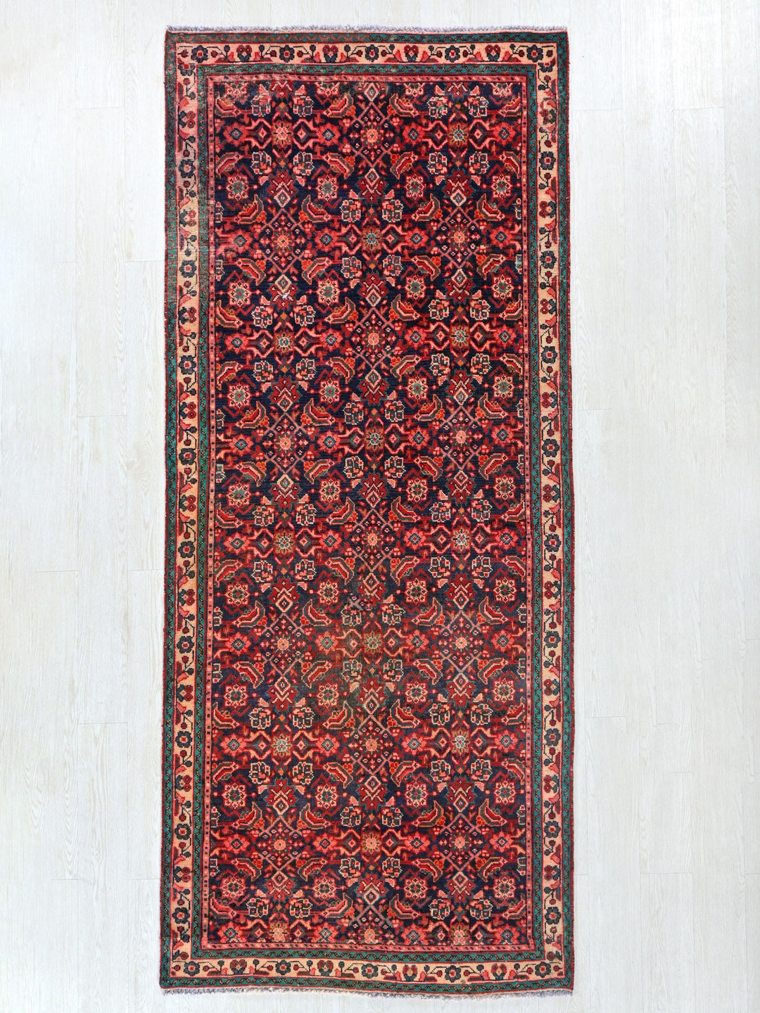 a red and black rug hanging on a wall