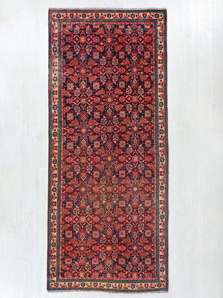 a red and black rug hanging on a wall