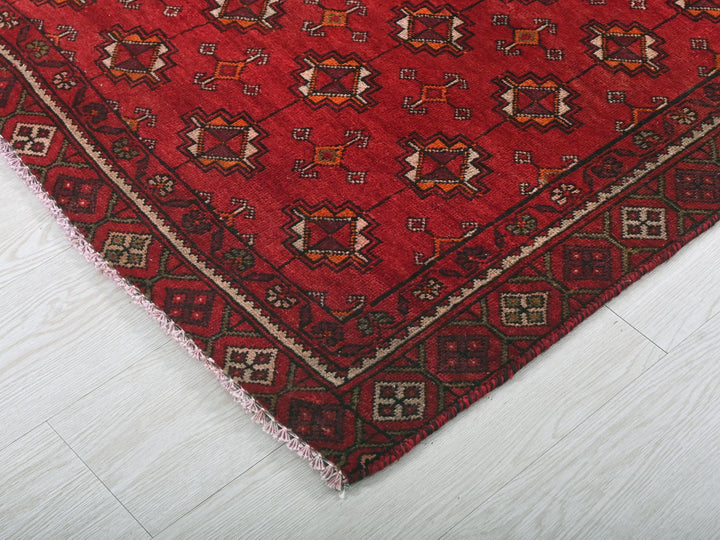 a red rug with a pattern on the middle of it