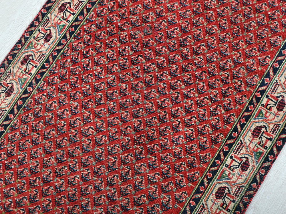 a close up of a red and black oriental rug