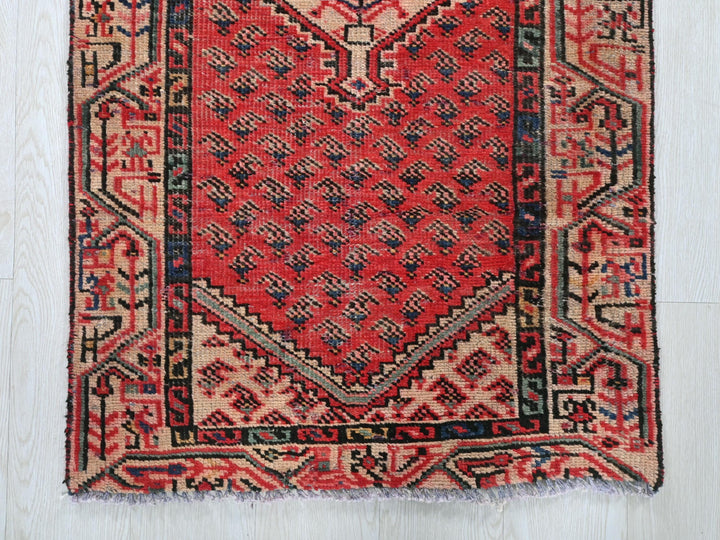 a red rug on a white wooden floor