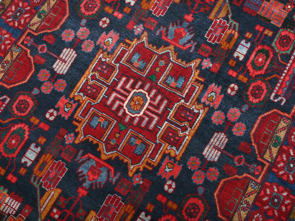 a red and blue rug with a design on it