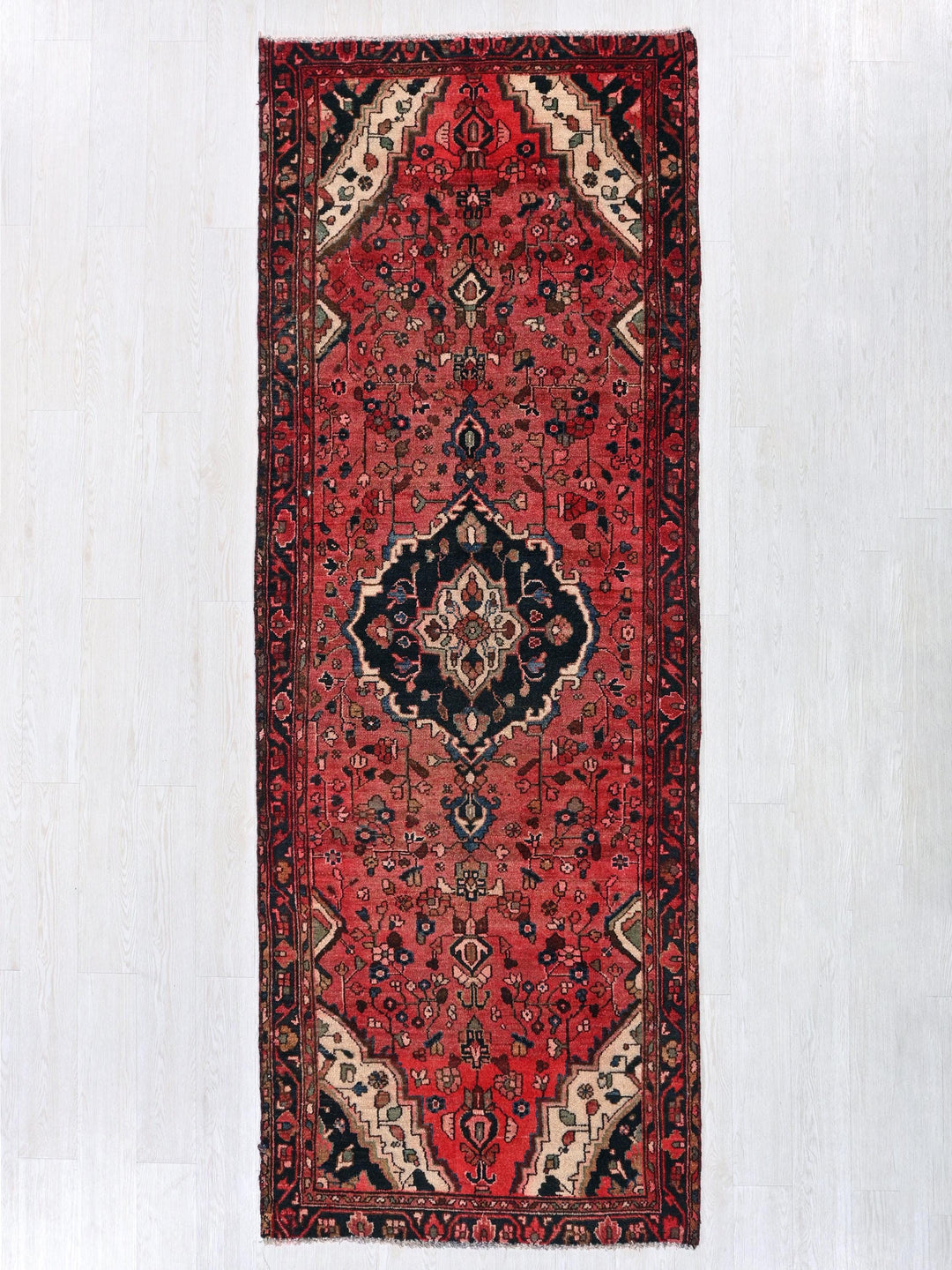 a red rug hanging up against a wall