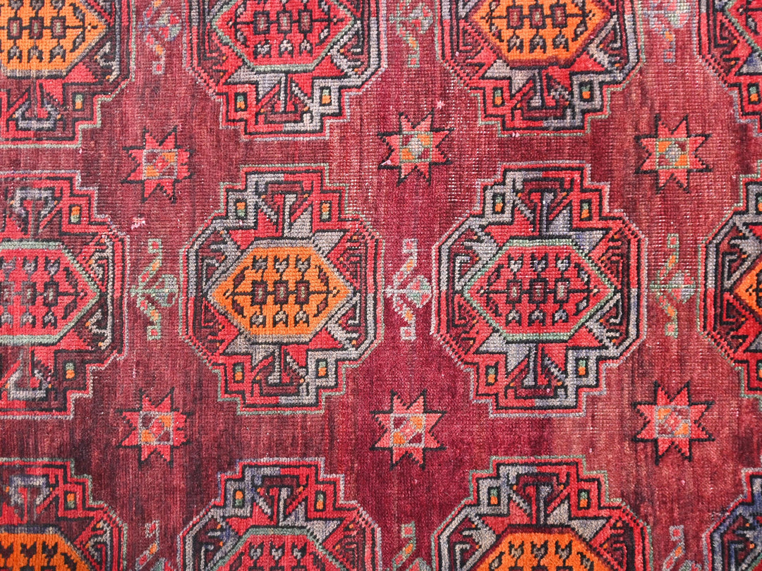 a close up of a red rug with a pattern on it