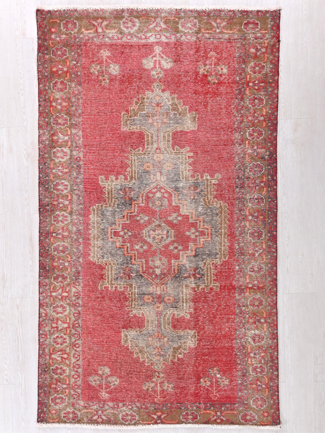 a red rug with an ornate design on it