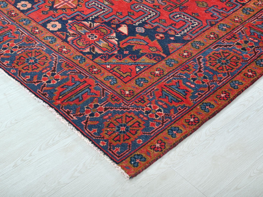 a red and blue oriental rug on a white floor