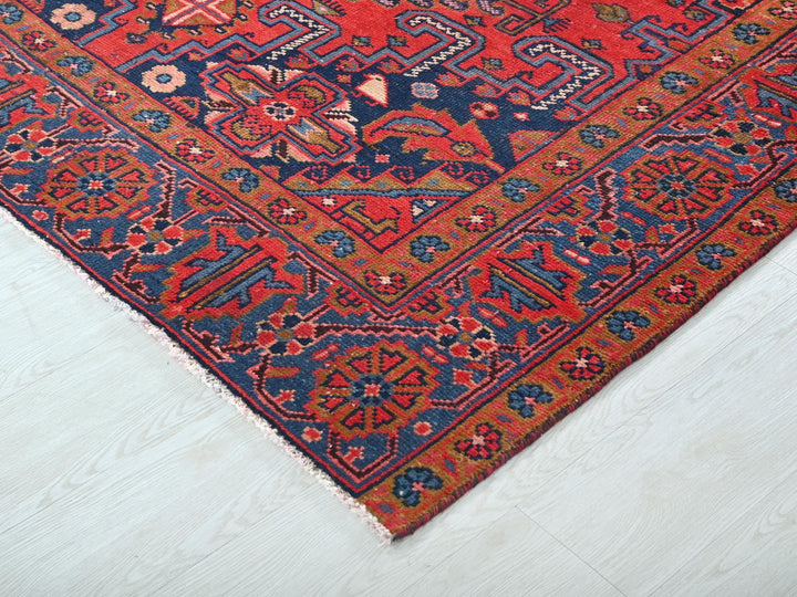 a red and blue oriental rug on a white floor