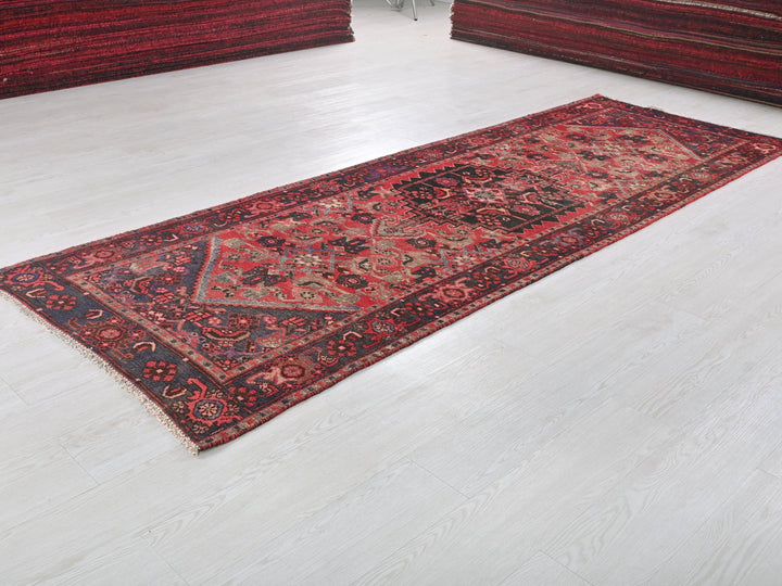 a red rug is laying on a white floor