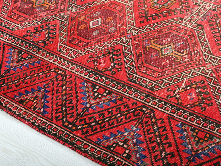 a red rug is laying on the floor