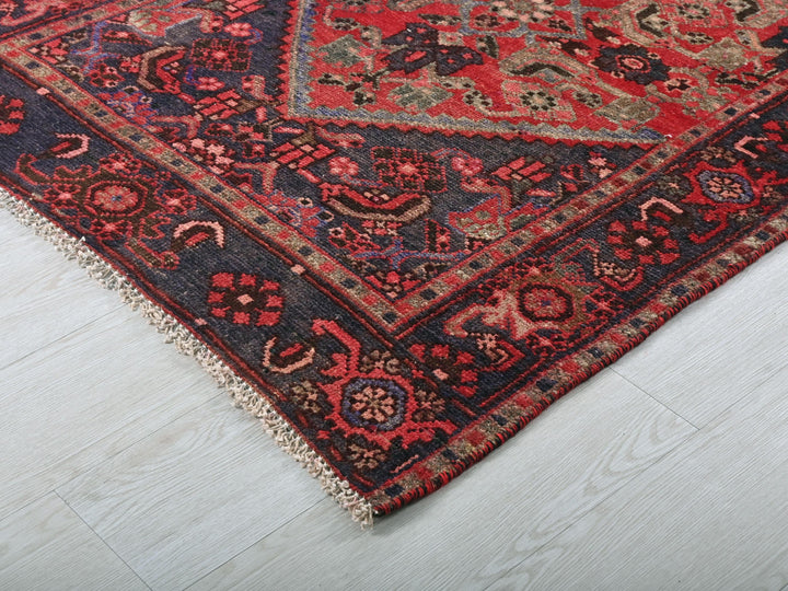 a red and blue rug on a white floor