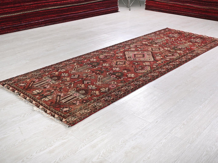 a red rug is laying on a white floor