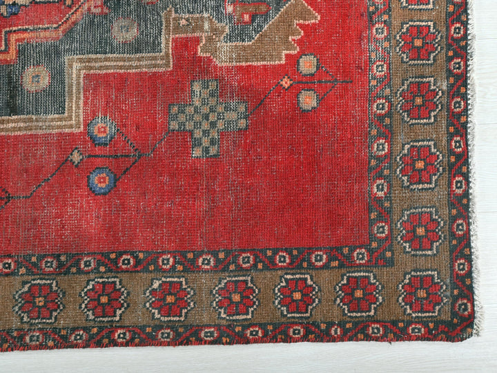 a red rug with a design on it