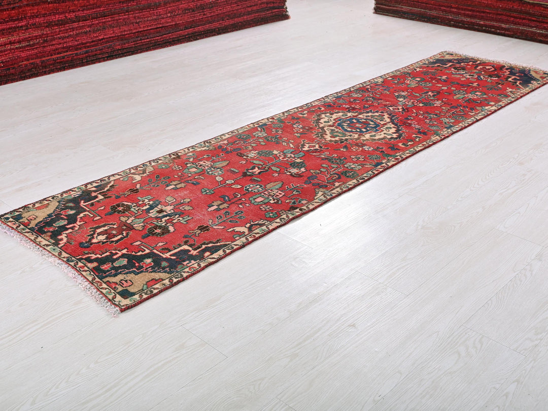 a red rug laying on a white floor