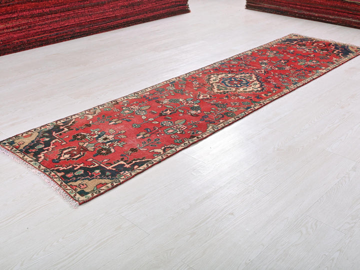 a red rug laying on a white floor