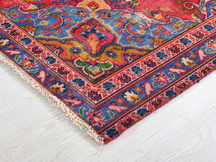 a colorful oriental rug on a white wooden floor