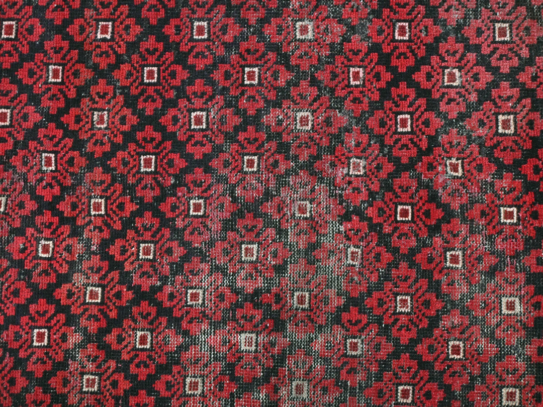 a close up of a red and black patterned cloth