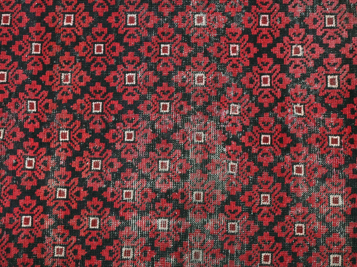 a close up of a red and black patterned cloth