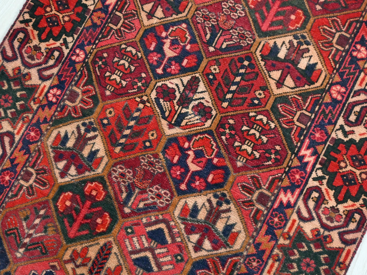 a red and blue oriental rug on a white floor