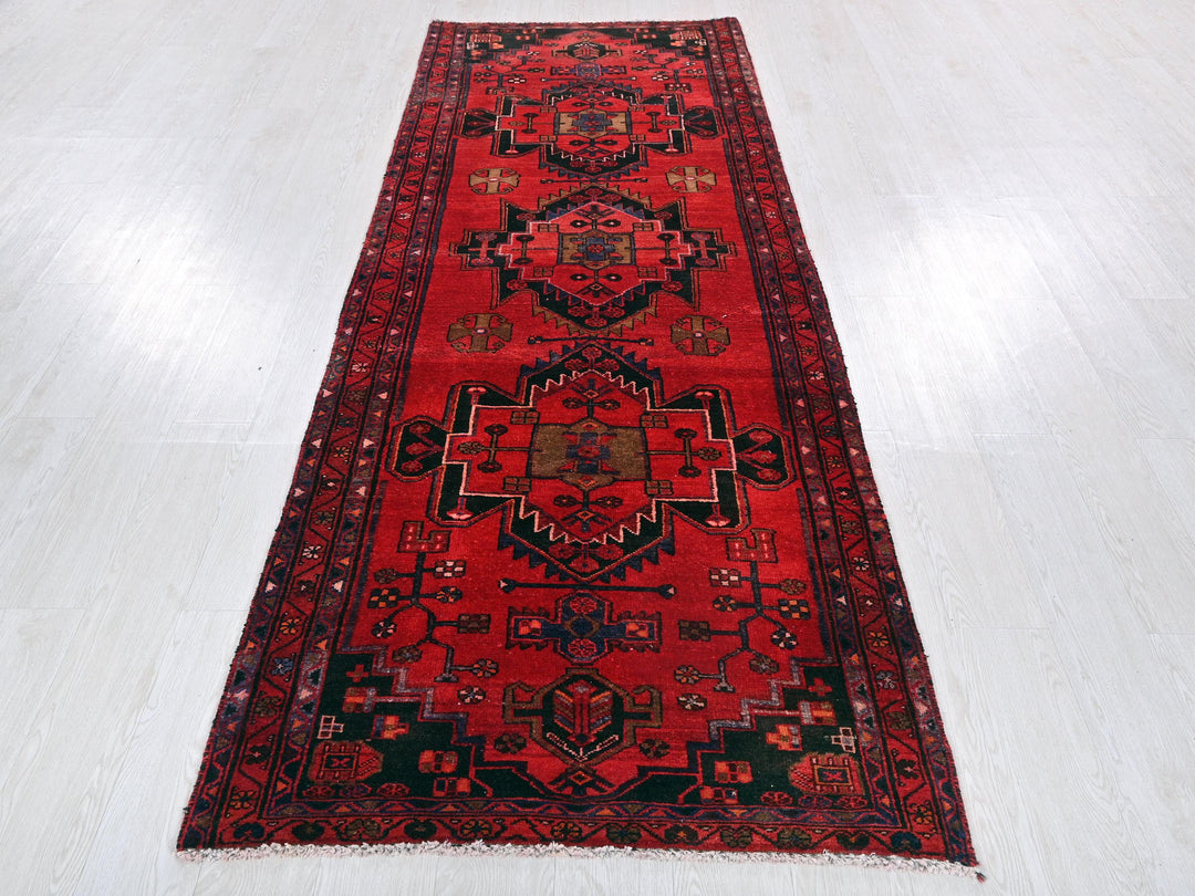 a red runner rug on a white floor