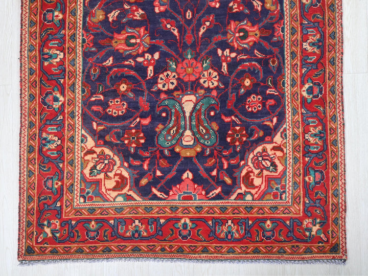 a blue and red rug on a white floor