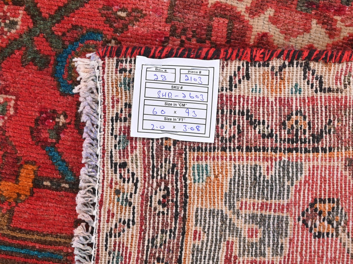 a pile of oriental rugs with a price tag