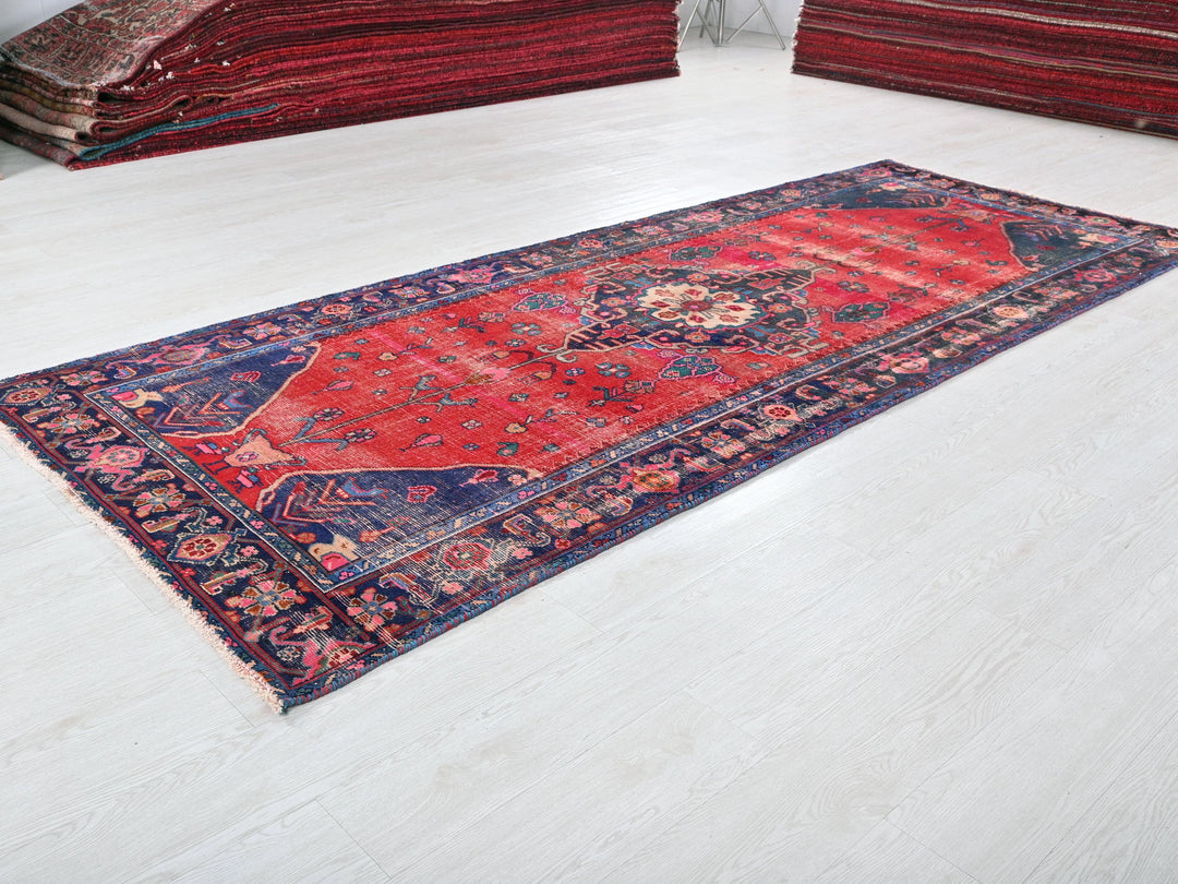 a red rug is laying on a white floor