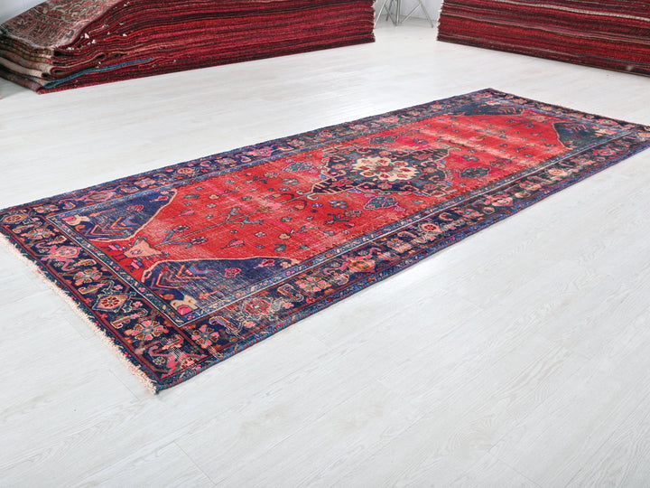 a red rug is laying on a white floor