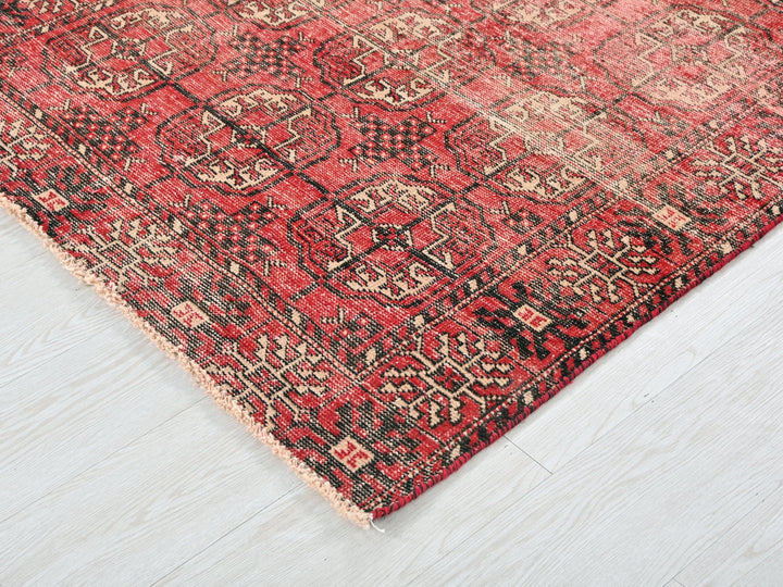 a red and black rug on a white floor