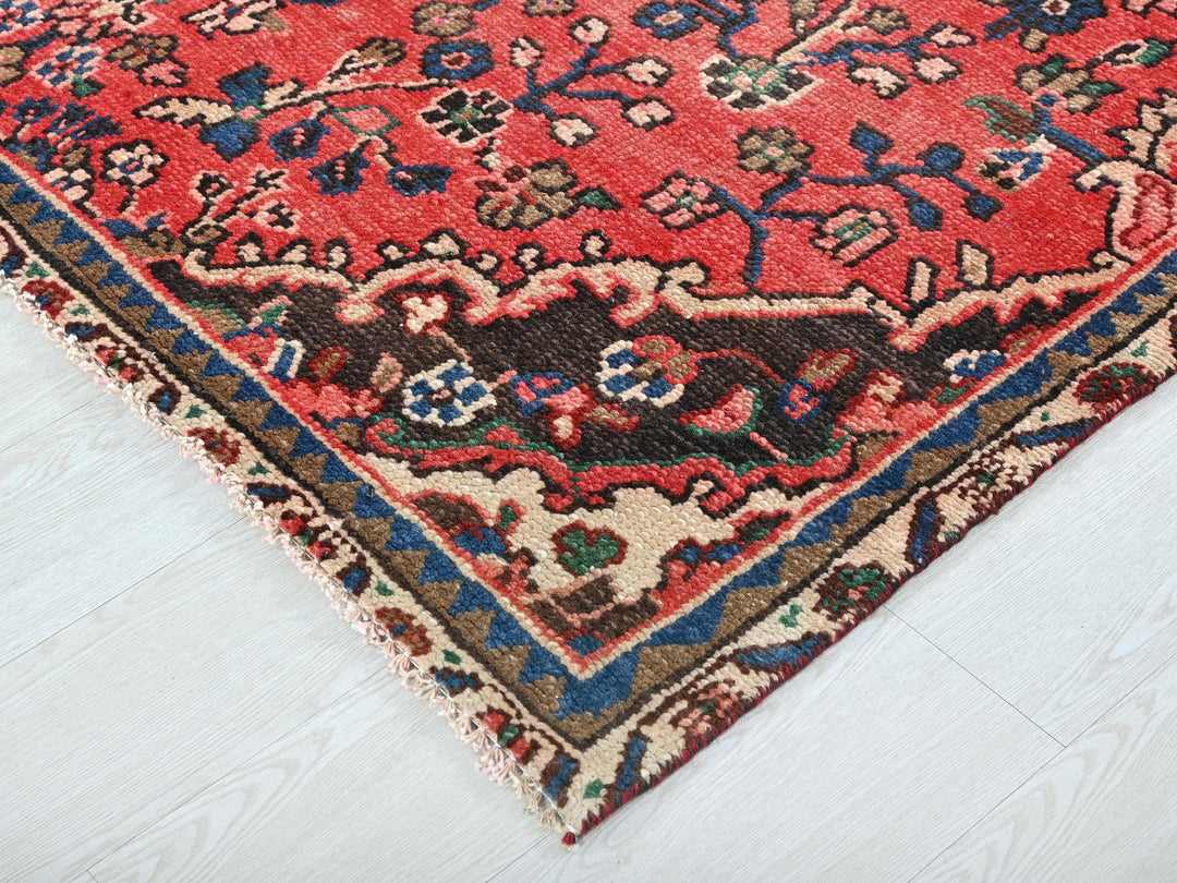 a red oriental rug on a white floor