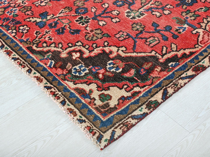a red oriental rug on a white floor