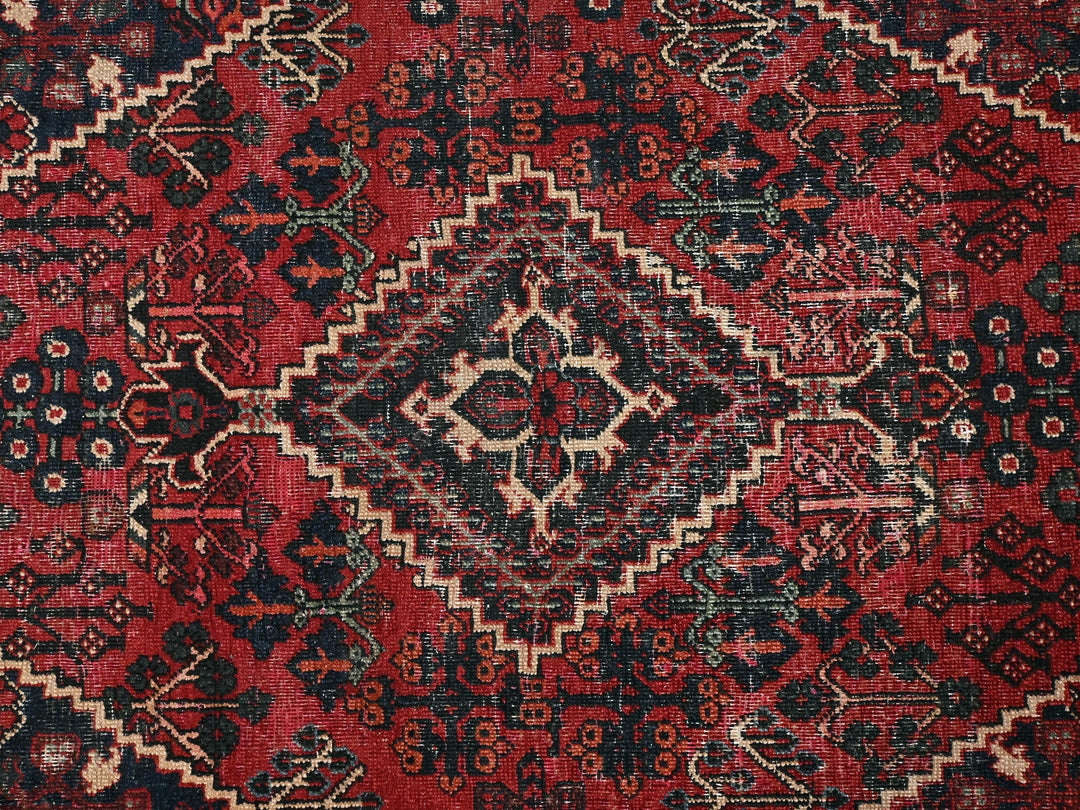 a red and black oriental rug with a diamond pattern