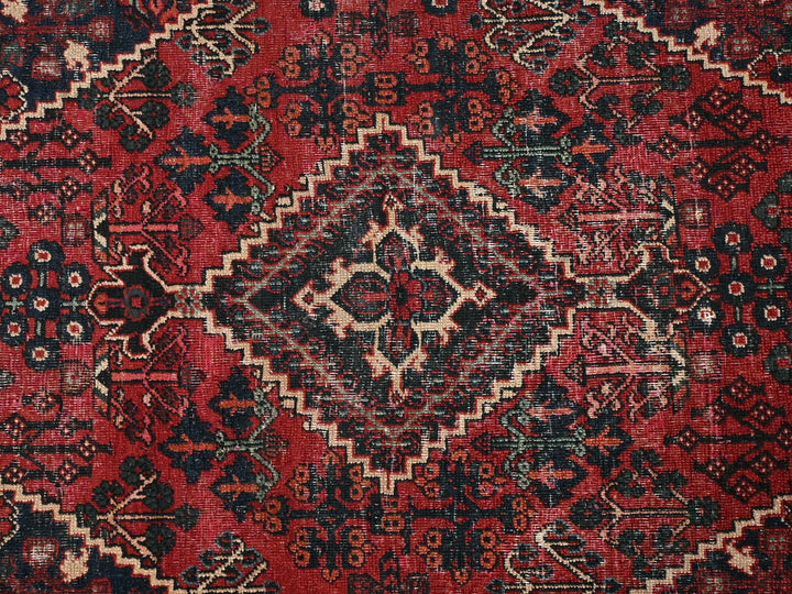a red and black oriental rug with a diamond pattern