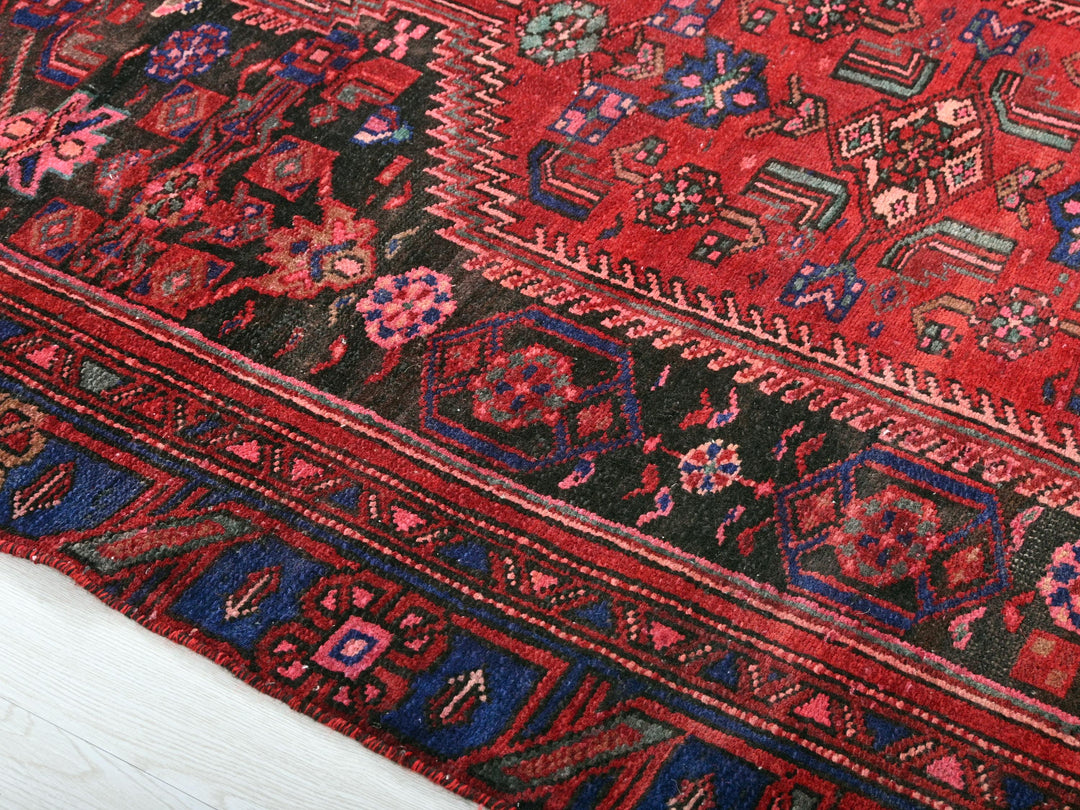 a close up of a red oriental rug